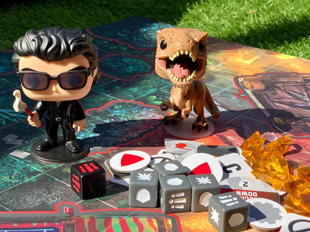 Tyrannosaurus and Dr Malcolm figures on playing board Tyrannosaurus and Dr Malcolm figures on playing board